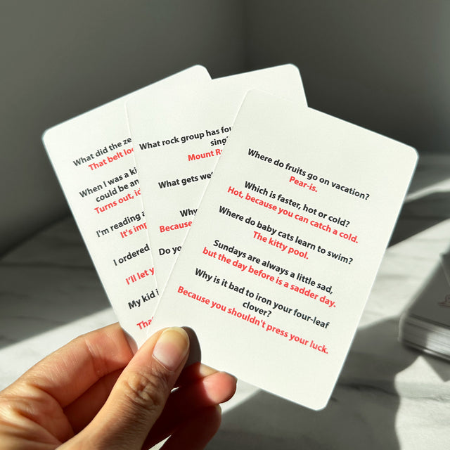 Hand Holding Dad Jokes Cards by Pikkii