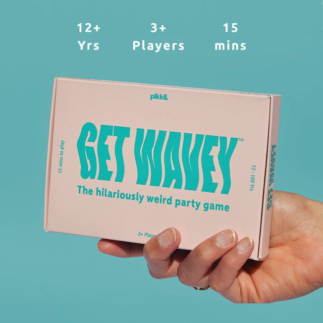 Get Wavey by Pikkii Hand Holding Front of Packaging on Teal Background with Gameplay Icons - Suitable for 3 or more players ages 12+, 15 mins to play