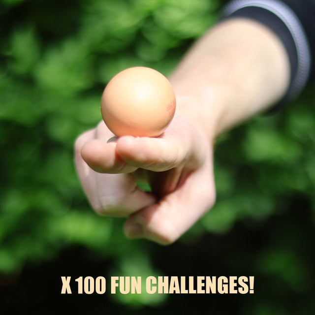 The Egg Game by Pikkii includes 100 fun challenges - lifestyle image of player balancing egg on two fingers