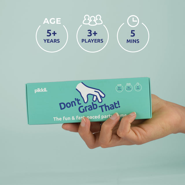 Don't Grab That Game by Pikkii hand holding packaging with gameplay details - suitable for 3 or more players ages 5+. Game duration 5 mins