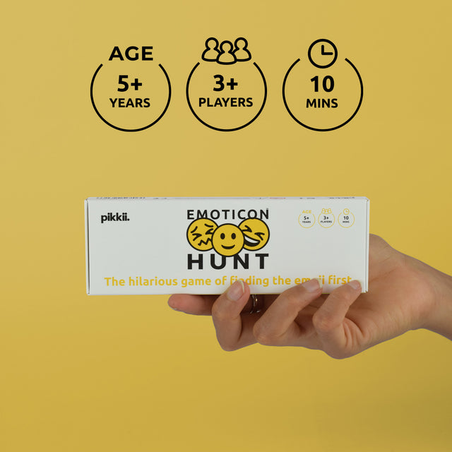 Hand holding Emoticon Hunt by Pikkii packaging - Suitable for 3 or more players ages 5 plus. Game duration 10 mins