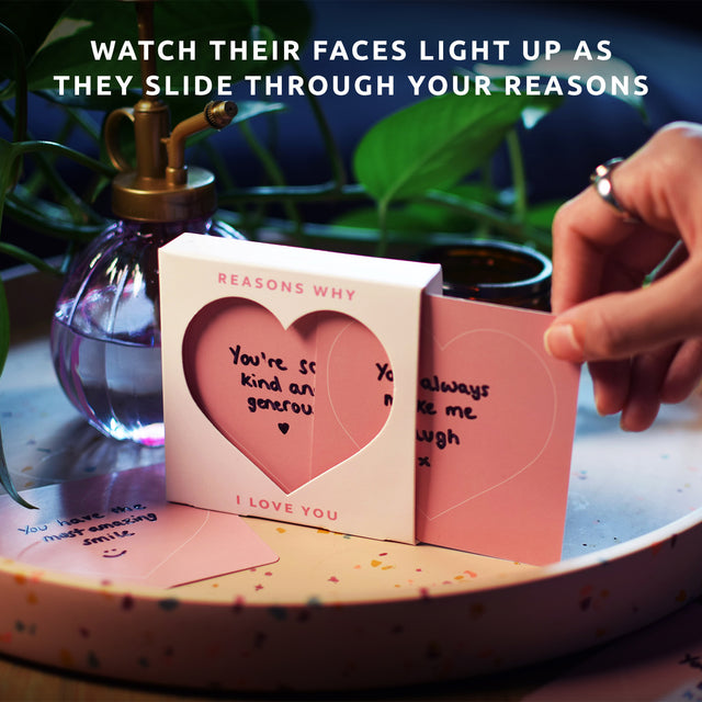 Reasons why I love you slide box by Pikkii on coffee table with hand sliding card out - watch their face light up as they slide through your reasons