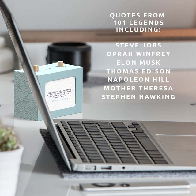 Pikki's 101 Motivational Quotes Scroll Box on a desk next to a laptop