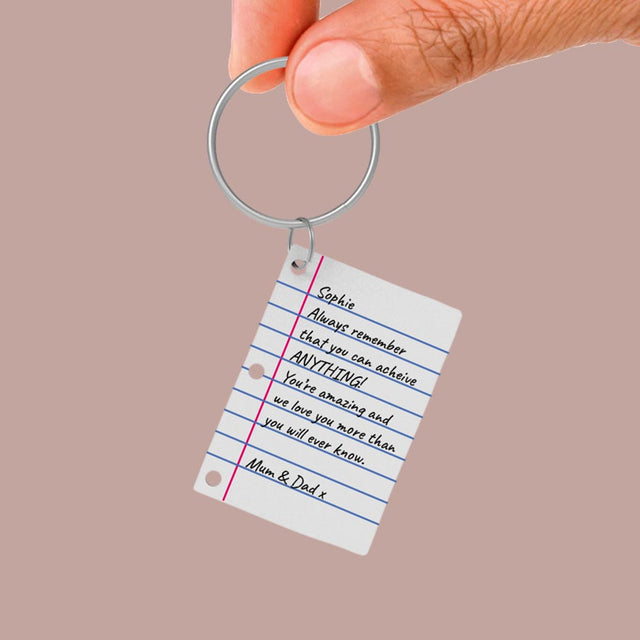 Close up of hand holding Pikkii Diy Shrink Little Lined Letter Keychain with Personalised message