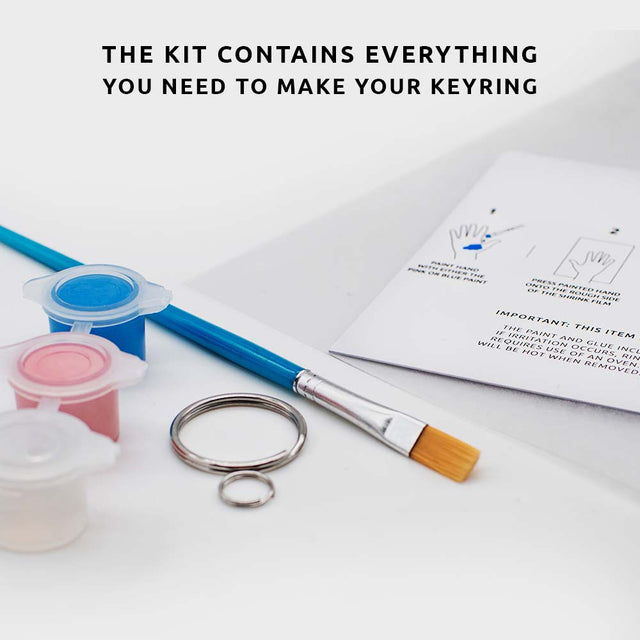 Pikkii Shrink HandPrint keyring kit complete with paint paint brush and instructions over white service