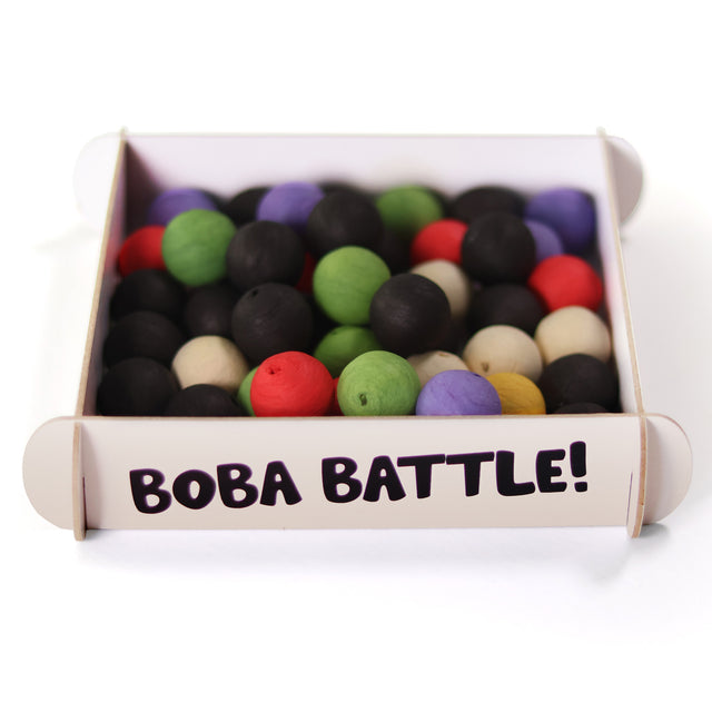 Side view of the Boba Battle by Pikkii party game setup, featuring a game arena filled with colorful cotton paper boba balls.