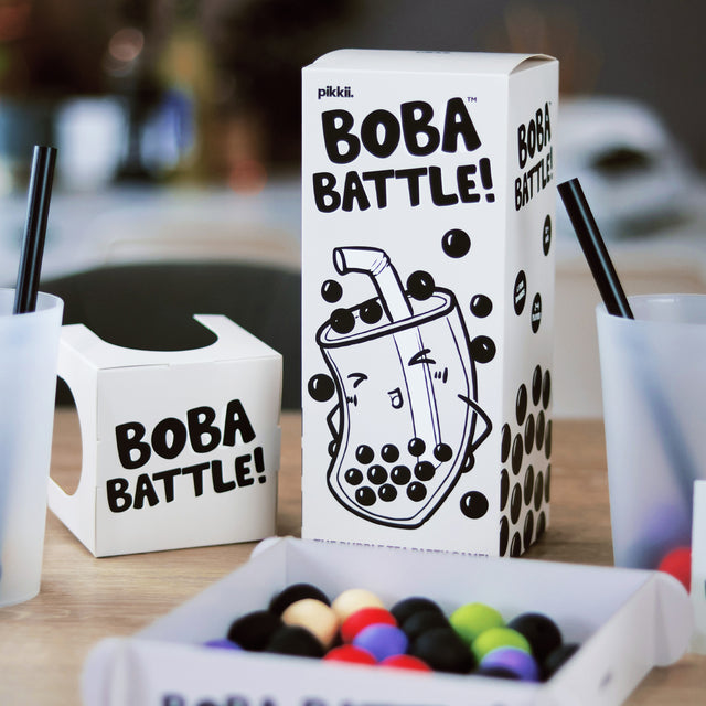 Close up of Boba Battle by Pikkii game set up including arena filled with cotton paper boba balls, cups and straws.