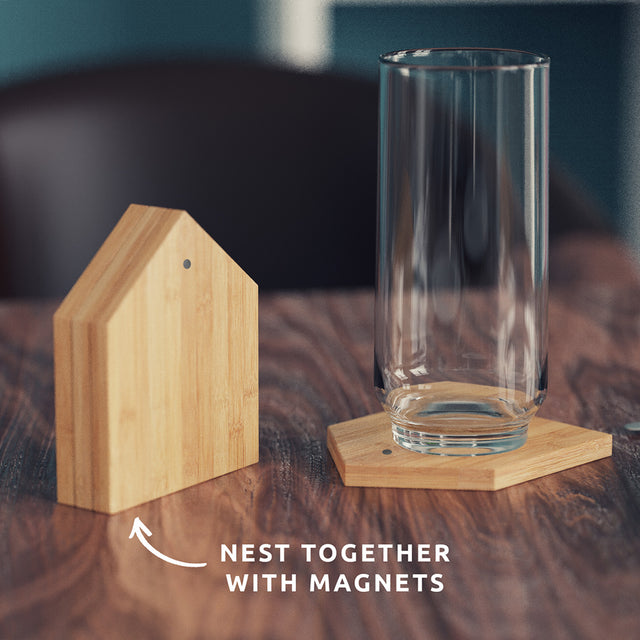 Pikkii - Magnetic Bamboo House Coasters on Dining Table with Glass with Text Overlay 'Nest together with magnets'