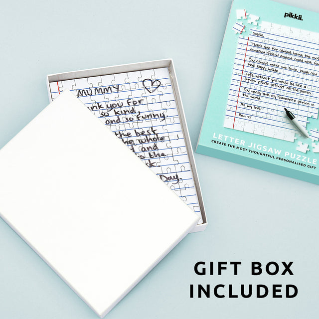 Pikkii's Blank Personalised Letter Jigsaw with Blank Gift Box over light teal background next to packaging