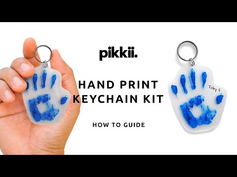 Child following instructions on how to make a keyring with Hand Print KeyChain kit by Pikkii
