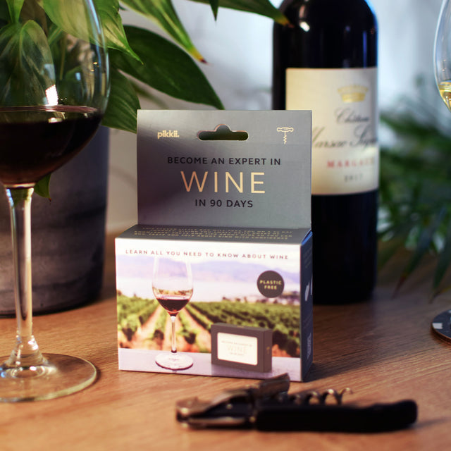 Become an expert in wine in 90 days slide box by Pikkii packaging on countertop with wine bottle and wine glass