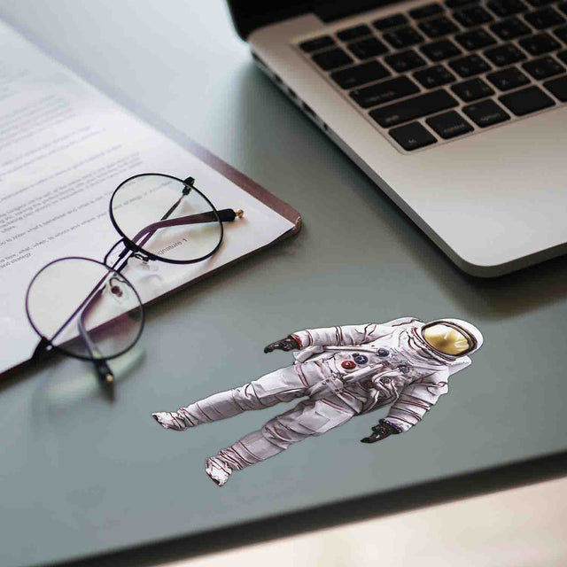 Pikkii Fun Microfiber Cloth - Astronaut Cloth Being Displayed on Desk With Glasses and LAptop