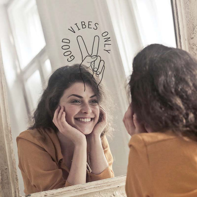 woman smiling in front of mirror with good vibes  decals
