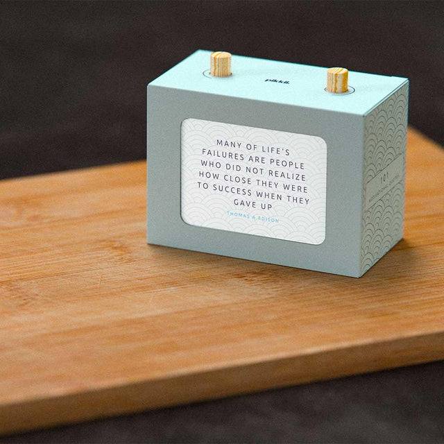 101 Motivational Quotes Box on shelf Thomas Edison Quote on wooden surface