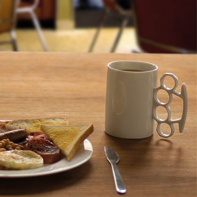 White Kuckle Duster Mug with white handle near Ful English Breakfast in cafe