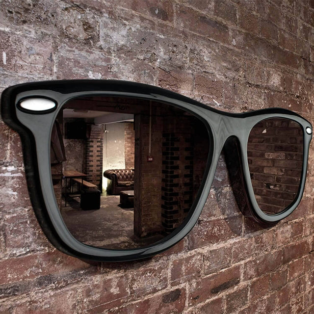 Pikki Looking Good Sunglasses Mirror at an angle hanging on Brick Wall