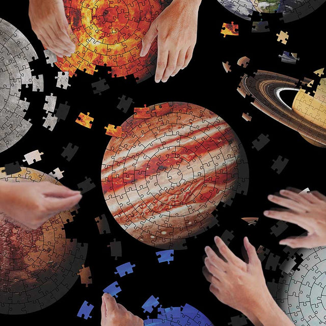 Players racing to complete their Planet Jigsaw Puzzle first Playing Fun Christmas Gifts together over Black Background