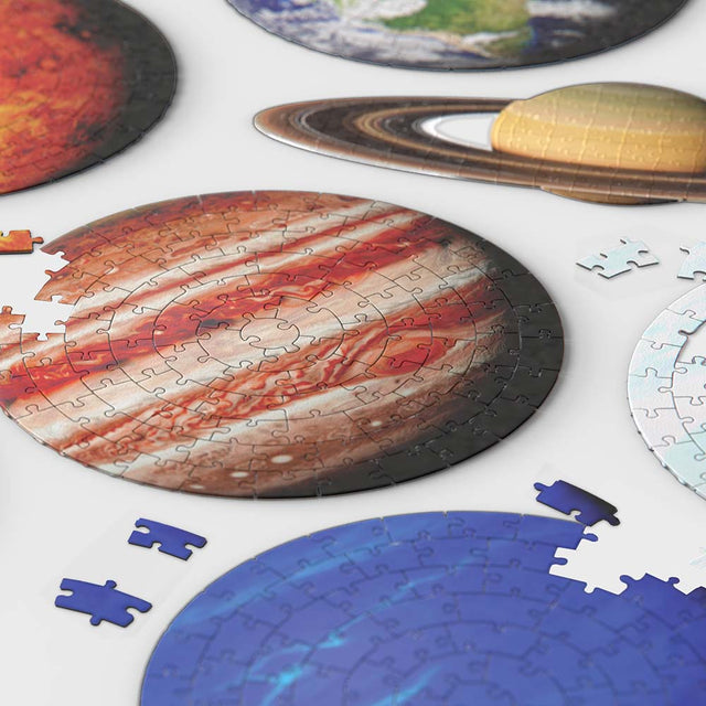 Close up of Pikkii's Planet Jigsaw Puzzles on white table