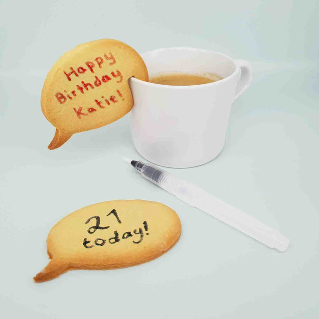 Pikkii Speech Bubble Personalised Biscuits on cup of coffee with pen on clear background
