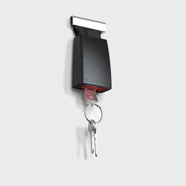 Pikki Seatbelt Buckle Key Holder with keys and keyring plugged in on white background